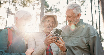 Buy stock photo Hiking, morning and senior people with phone for wellness, fresh air and online app for navigation. Travel, flare and elderly friends on smartphone for direction, trekking or exercise on nature trail