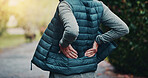 Workout, injury and hands with back pain, outdoor or joint tension with pressure in morning on break. Park, exercise and old person with muscle strain after training accident, hurt and bad posture