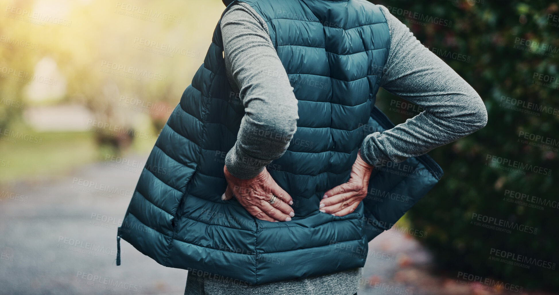Buy stock photo Workout, injury and hands with back pain, outdoor or joint tension with pressure in morning on break. Park, exercise and old person with muscle strain after training accident, hurt and bad posture