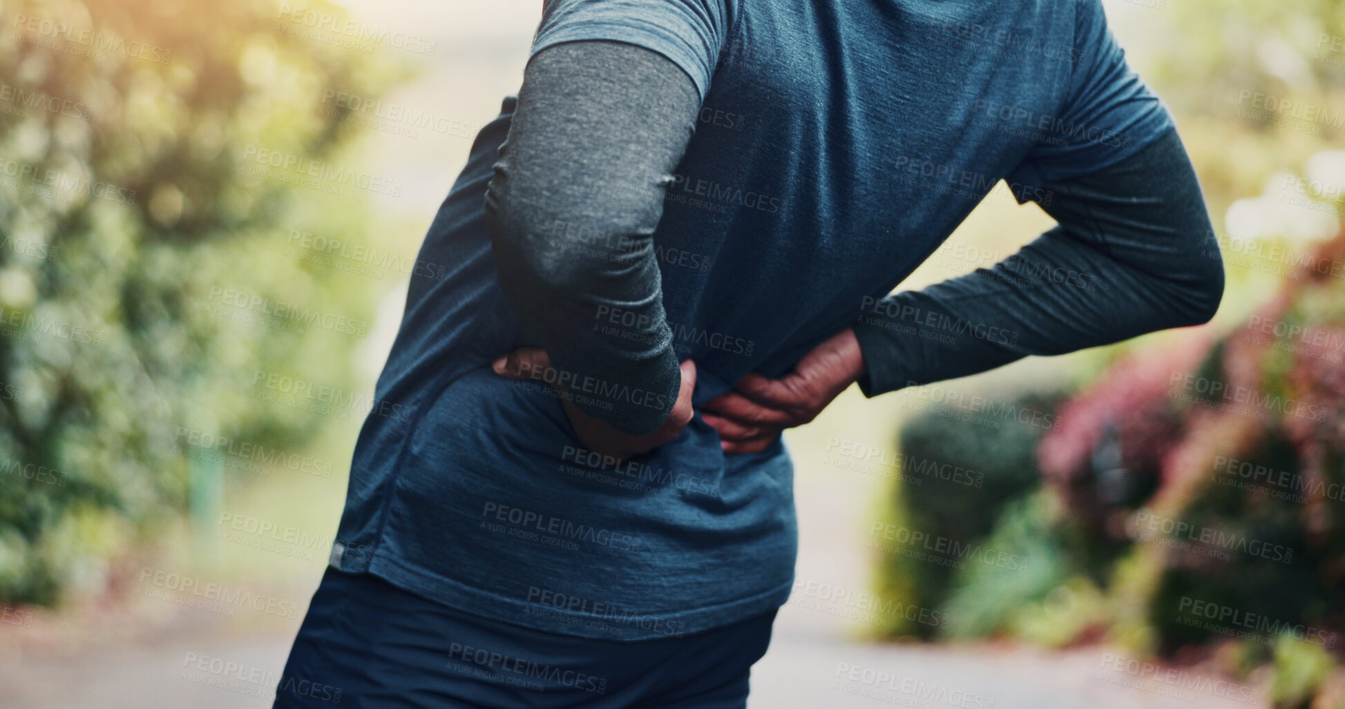 Buy stock photo Workout, injury and hands with back pain at park, fatigue or joint tension with pressure in morning. Outdoor, exercise and old person with muscle strain after training accident, space and bad posture