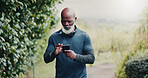 Outdoor, reading and old man with phone for fitness, running route research or find training playlist. Park, workout app or black person with tech for trail navigation, steps count or music selection