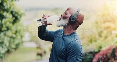 Buy stock photo Fitness, headphones and old man with water at park, wellness or listening to music on workout break. Streaming, space and senior black person with tech for audio, retirement and liquid after exercise