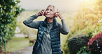 Outdoor, fitness and old woman with headphones at park, thinking and listening to music for workout. Streaming, space and senior person with technology for audio, retirement and exercise for wellness
