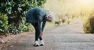 Buy stock photo Senior, woman and ankle injury with headphones on street for workout accident, pressure or strain. Elderly, female person or sore joint with leg pain or discomfort for fibromyalgia or muscle tension
