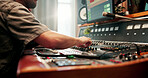 Man, hands and audio engineer with sound board for radio broadcast, live streaming or production. Male person, podcaster or buttons with switches, console or control panel for commercial podcast
