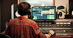 Back, computer screen and music with man in recording studio for production or sound engineering. Display, equipment and synthesizer with DJ person in control room for balance, editing or mixing