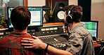 Producer, team and mixing in recording studio, headphones or music quality on console. Collaboration, audio and men editing on screen for creative production, software and back with sound engineer