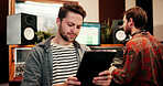 Tablet, man and sound engineer in recording studio, digital editing software and music production. Mixing app, tech and people with audio effects for acoustic resonance, amplify song and control room