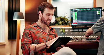 Buy stock photo Tablet, sound engineer and reading with man in music studio for audio production, album listing and dj review. Synth app, recording project, song composer with producer for musician mixer and track