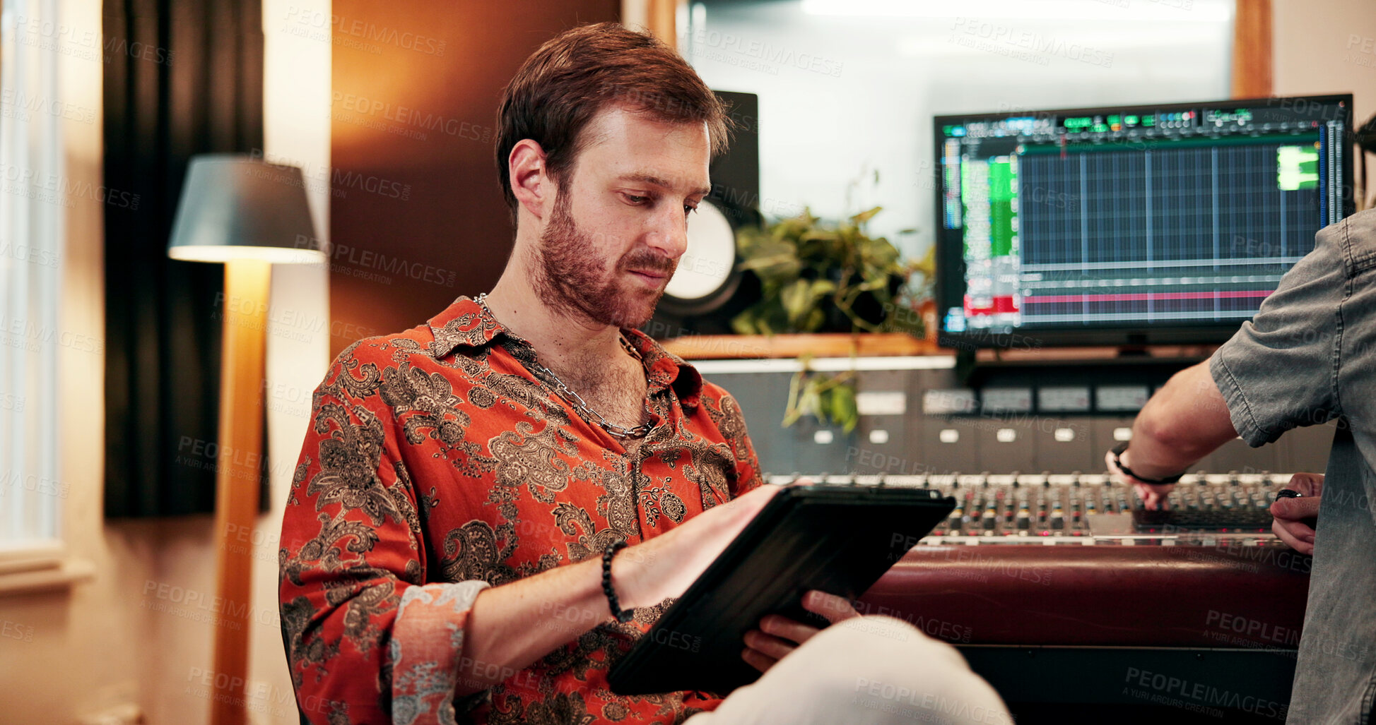 Buy stock photo Tablet, sound engineer and reading with man in music studio for audio production, album listing and dj review. Synth app, recording project, song composer with producer for musician mixer and track