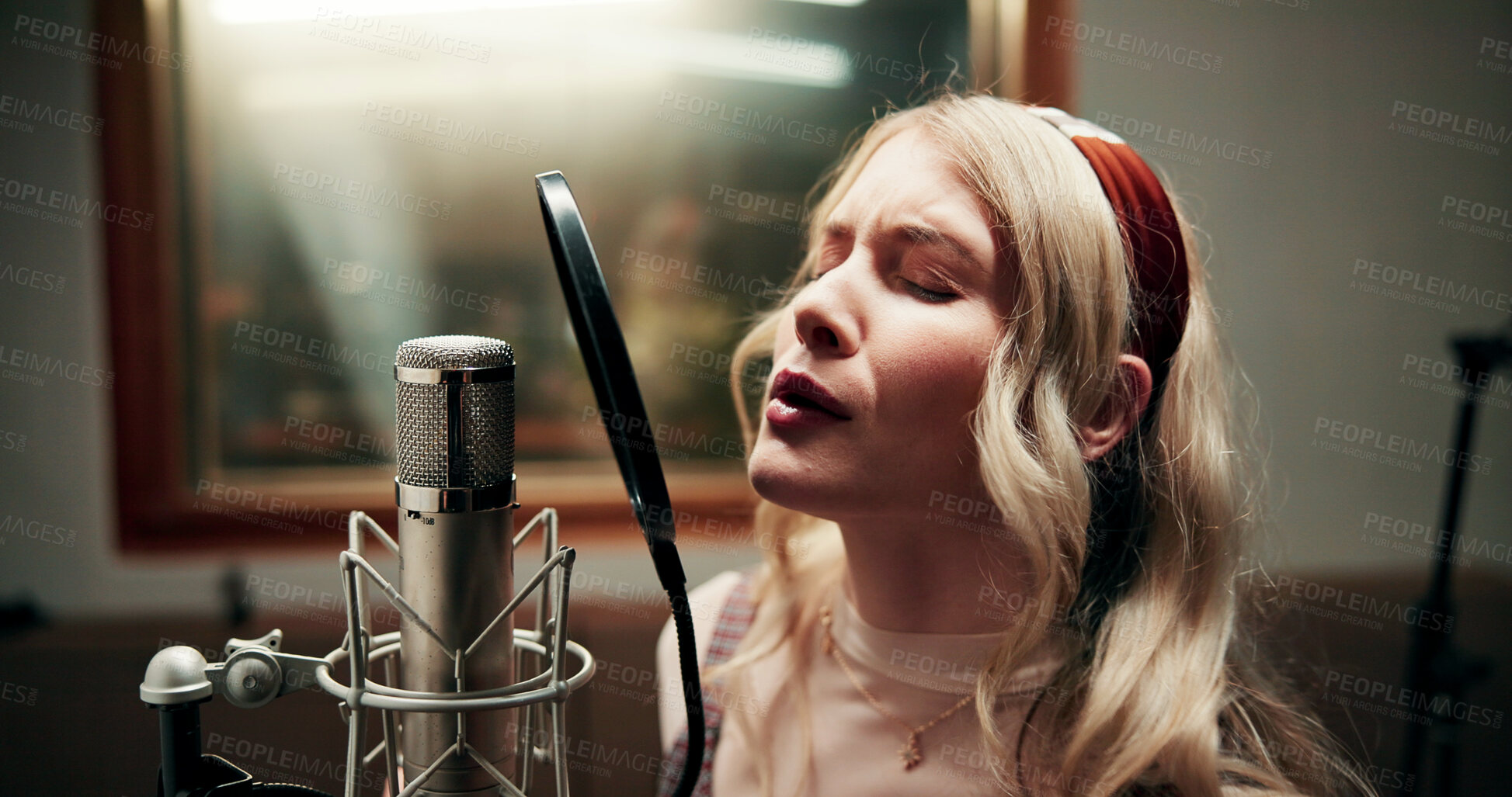 Buy stock photo Microphone, woman and singing in recording studio for audio production, music and song with talent. Musician, artist and person with vocal for sound, album and voice with creative performance