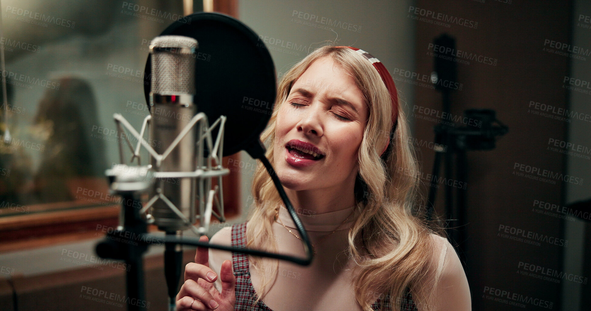 Buy stock photo Microphone, woman and singing in recording studio for music, audio production and song with talent. Musician, artist and person with vocals for sound, album and voice with creative performance