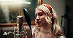 Microphone, creative and woman singing in recording studio for audio production, music and song. Musician, artist and person with vocal talent for sound, album and broadcast voice with performance