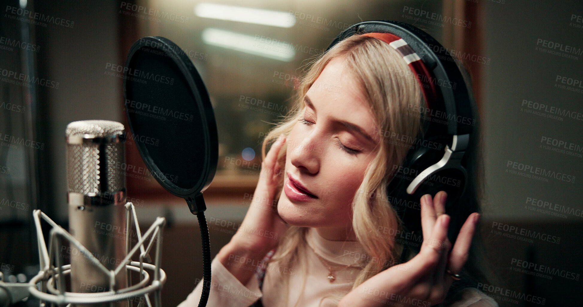 Buy stock photo Singer, microphone and woman in studio with headphones, production or musician in performance. Talent, music recording or artist in booth with tech, song or sound entertainment for creative album.