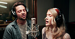 Singing, microphone and people with headphones in recording studio, vocal capture and music artists. Tech, man and woman with performance for album feature, teamwork and talent for song production