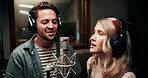 Singing, microphone and couple with headphones in recording studio, vocal capture and music artists. Tech, man and woman with performance for album feature, teamwork and talent for song production