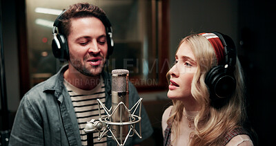Buy stock photo Singing, microphone and couple with headphones in recording studio, vocal capture and music artists. Tech, man and woman with performance for album feature, teamwork and talent for song production
