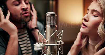Buy stock photo Sing, microphone and couple with headphones in recording studio, vocal capture and song rehearsal. Tech, music artist and people with performance for album feature, teamwork and talent for production