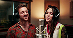 Creative, people and singing in recording studio with microphone, song performance and music production. Artist, team and singer at record label with headphones, talent and collaboration for album.