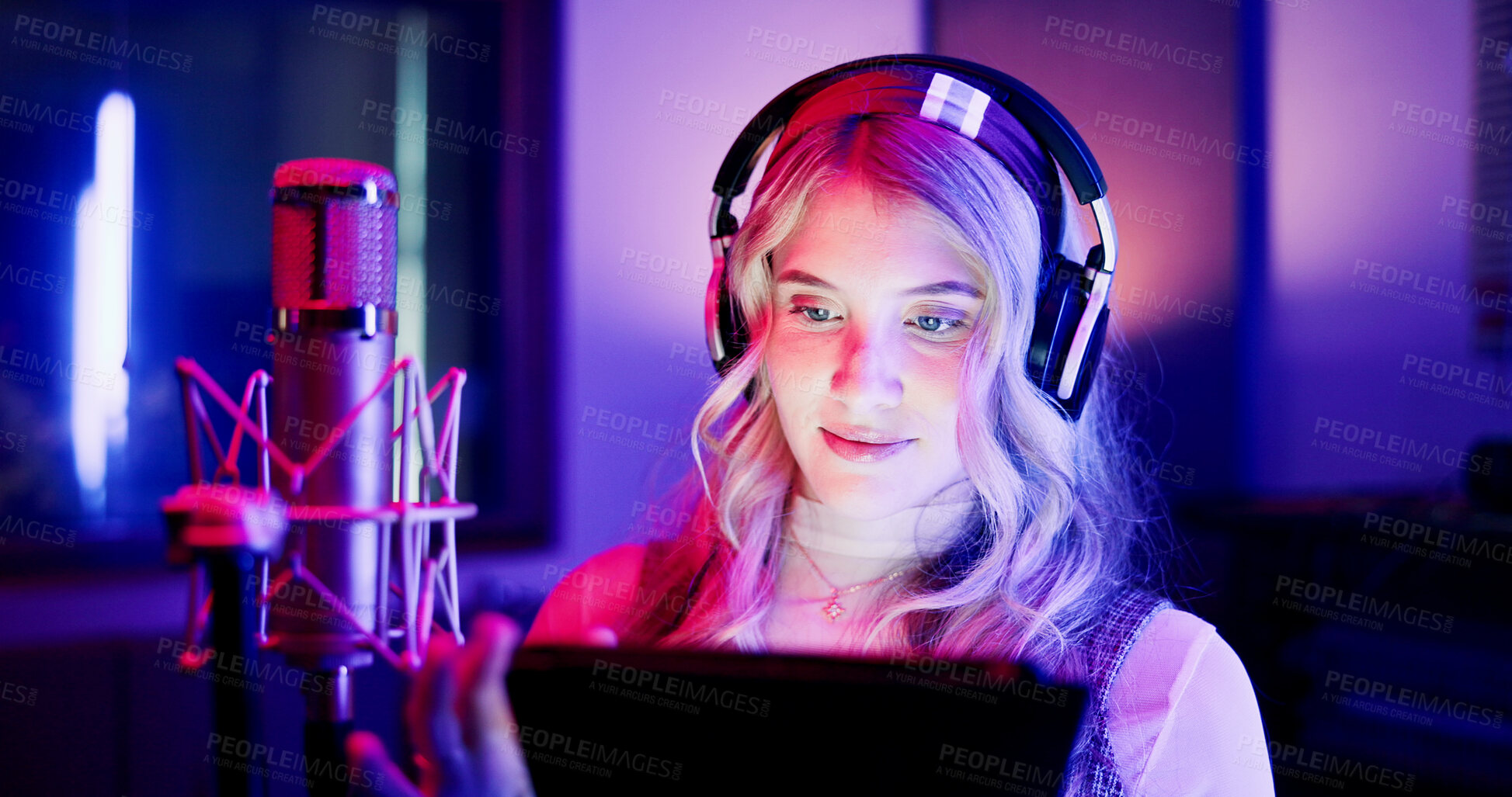 Buy stock photo Woman, neon and podcaster with mic on tablet for radio broadcast, podcast or live recording. Female person, announcer or journalist working late with technology or headphones for audio news on air