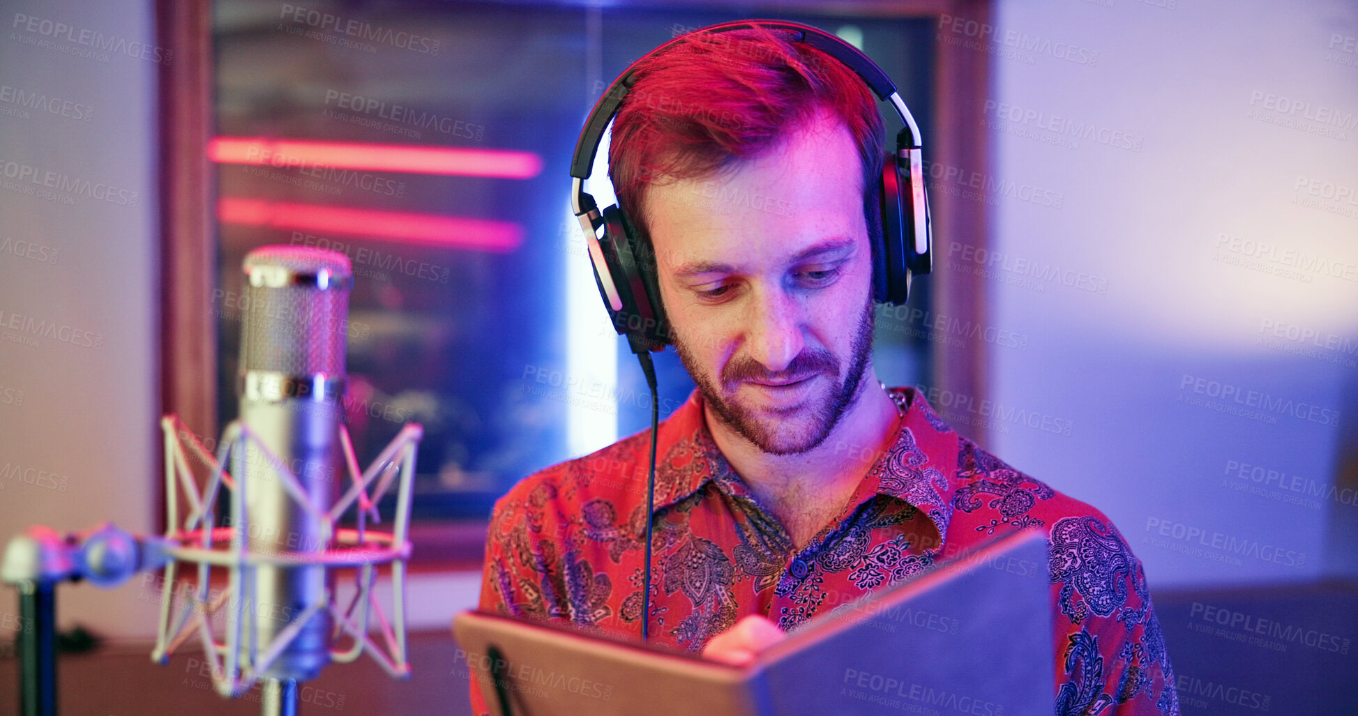 Buy stock photo Writer, notebook and man in recording studio, music production or song composition with neon light. Notes, headphones and songwriter writing lyrics for album idea, sound or creative musician with mic