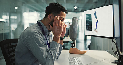 Buy stock photo Prosthetic leg, headache and man in lab, computer screen and bionic anatomy innovation. Scientist, programmer or person in workplace, robotics or migraine with burnout. tension or blue light exposure