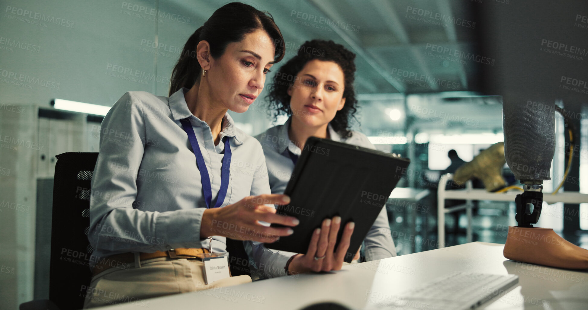Buy stock photo Women, tablet and laboratory for prosthetic leg research, report or future development. Prosthetist, teamwork and design for artificial limbs innovation with 3d foot, mobility aid and feedback chat