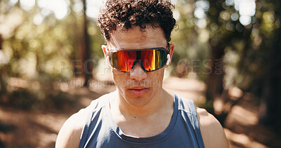 Buy stock photo Serious, athlete and man with earphones in nature, space and plan for exercise on break and fitness. Outdoor, runner and person with tech for audio, streaming and workout reflection for wellness