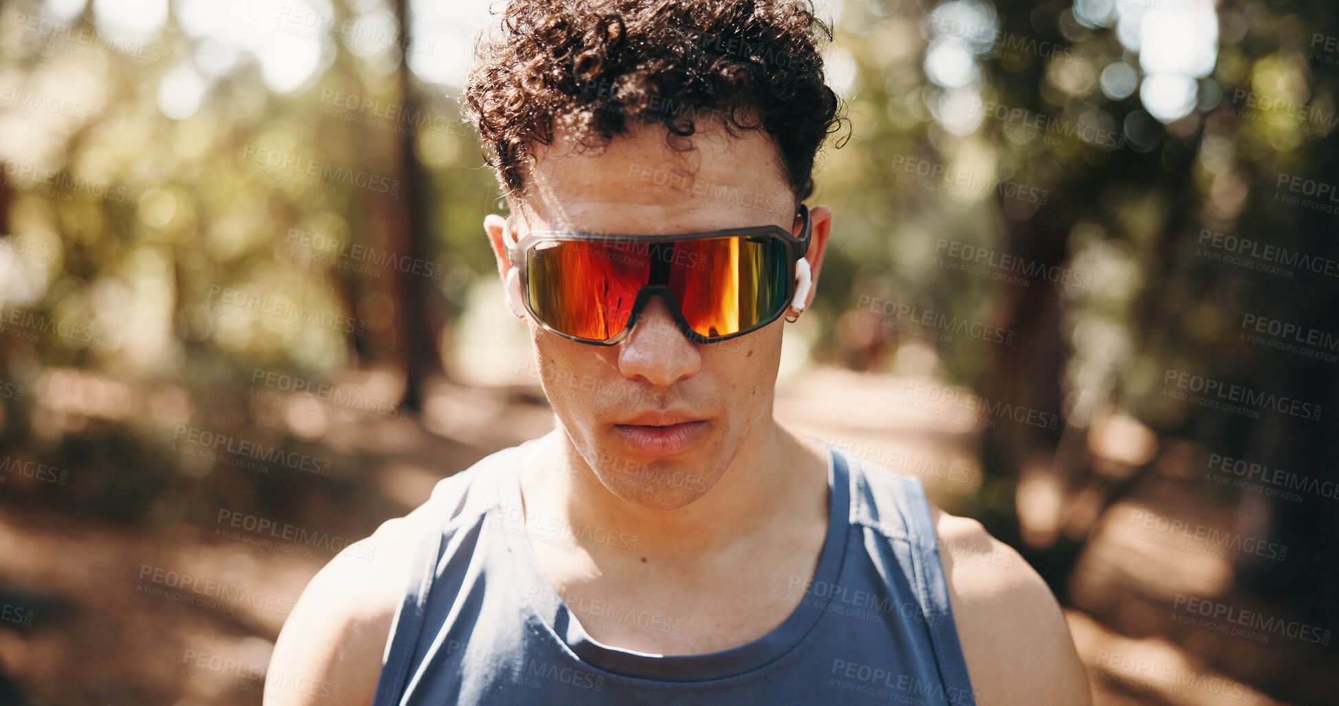 Buy stock photo Serious, athlete and man with earphones in nature, space and plan for exercise on break and fitness. Outdoor, runner and person with tech for audio, streaming and workout reflection for wellness