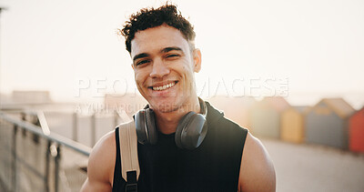 Buy stock photo Athlete, portrait and happy man on break at beach, fitness and confident after workout for wellness. Outdoor, runner and person with smile for health, rest and exercise with headphones and space