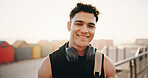 Fitness, portrait and happy man with headphones on break, athlete or confident after workout routine. Outdoor, runner and person with smile for wellness, resting and exercise with tech and space
