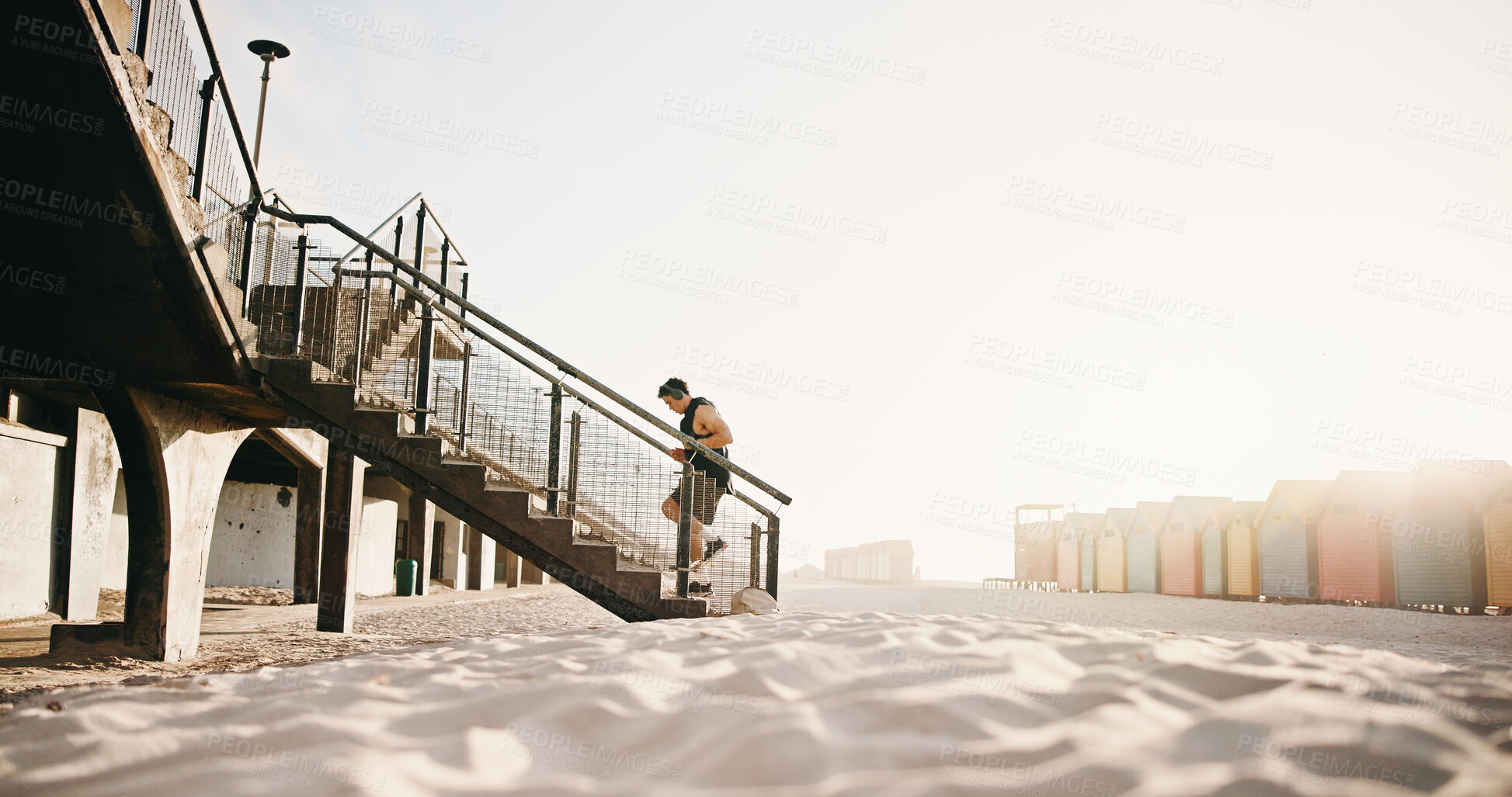 Buy stock photo Running, fitness and man on stairs by beach for exercise, workout and training for cardio, health and wellness. Athlete, sports and person with active hobby for steps, endurance and runner challenge