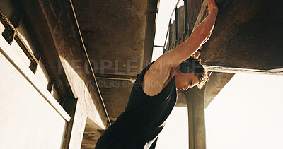 Buy stock photo Stretching, fitness and man with headphones by bridge for exercise, workout and training for mobility. Runner, athlete and person listen to music with warm up for wellness, flexibility and health