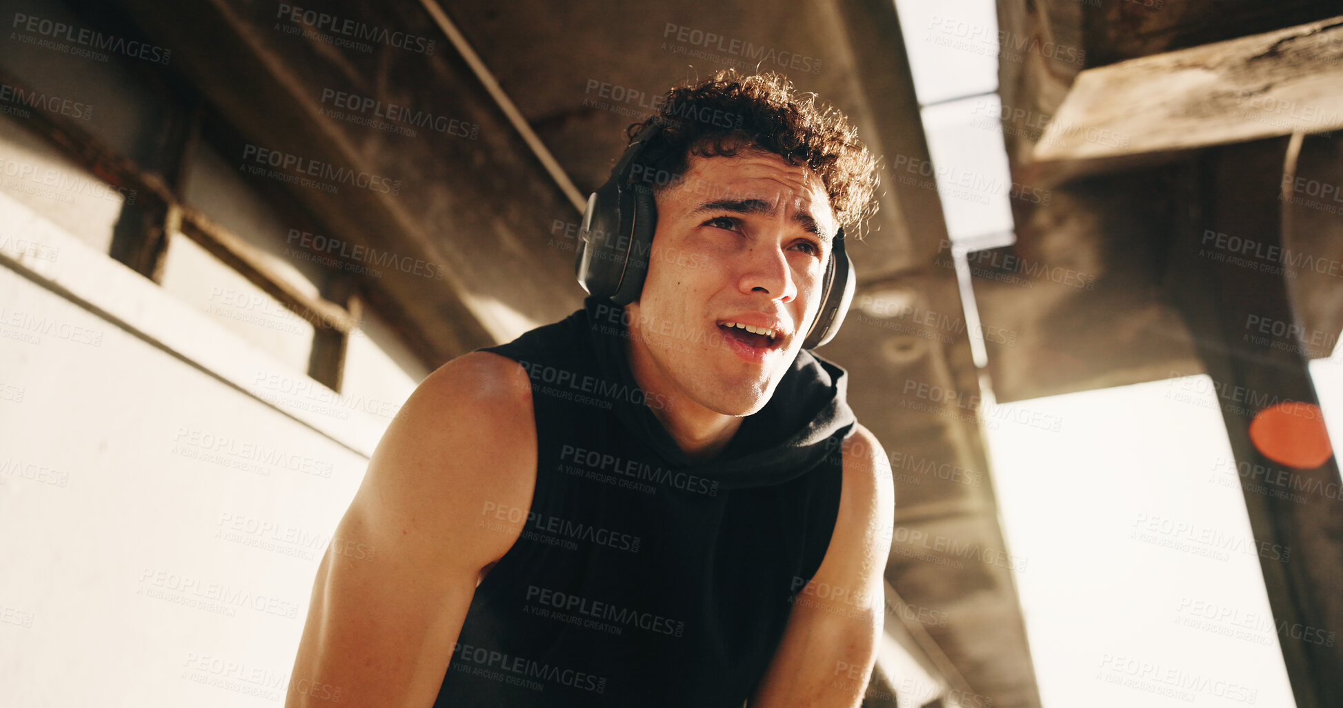 Buy stock photo Tired, athlete and man with headphones, bridge or reflection after exercise with music subscription. Outdoor, runner and person with tech for radio, fitness and thinking with fatigue on break or rest