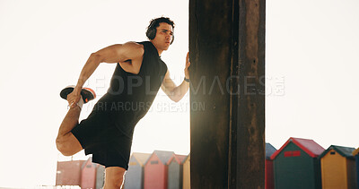 Buy stock photo Stretching, outdoor and man with headphones for exercise, workout and training for mobility, cardio and legs. Runner, city and person with warm up for wellness, fitness and listening to music