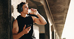 Fitness, water and man in nature with phone for social media after training, exercise and workout. Sports, athlete and person on smartphone for health app, internet and drink for hydration outdoor