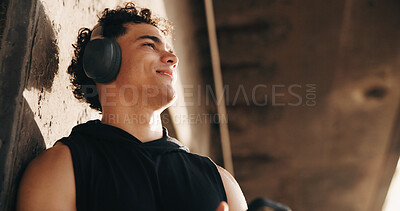 Buy stock photo Thinking, athlete and happy man with headphones after workout, remember and fitness plan for health. Outdoor, space and person with tech for audio, low angle and exercise reflection for wellness