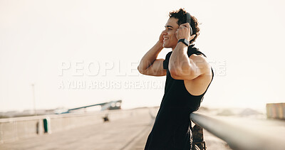 Buy stock photo Thinking, athlete and happy man with headphones on bridge, remember and plan for workout and fitness. Outdoor, runner and person with tech for audio, space or exercise reflection for wellness in city