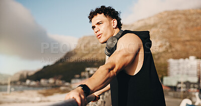 Buy stock photo Thinking, athlete and man on bridge for break, space and planning for fitness after exercise in city. Outdoor, runner and person with headphones for audio, rest and workout reflection for wellness