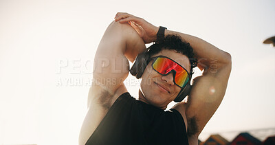 Buy stock photo Stretching, fitness and man with sunglasses outdoor and music for exercise, workout and training for mobility. Runner, athlete and male person with warm up for wellness, flexibility and health
