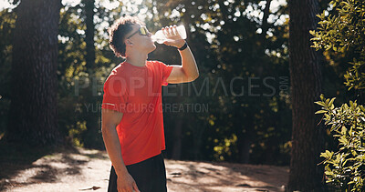 Buy stock photo Fitness, rest and man with water in nature for exercise, training and drinking on break. Outdoor, space and person with liquid for wellness, health and active hobby for hydration, thirsty and sports