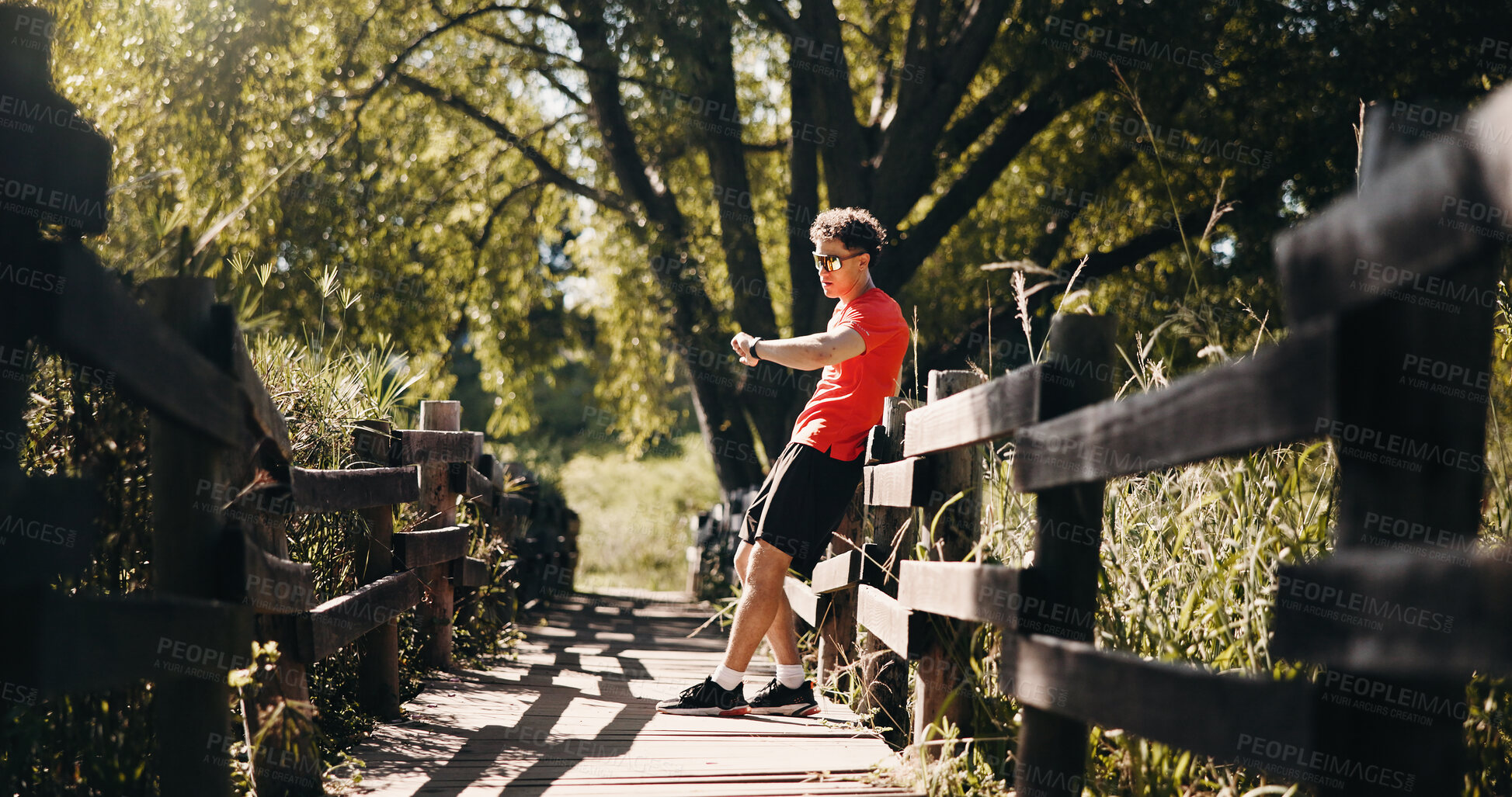 Buy stock photo Bridge, smart watch and man with fitness, rest and digital app to track progress. Health stats, runner and person in nature, check time and results for challenge, heart rate and performance monitor