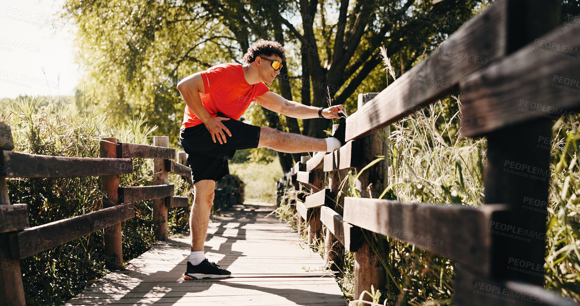 Buy stock photo Legs, fitness and man in park stretching to start exercise, workout and training for cardio. Runner, athlete and person with warm up for endurance, mobility and wellness for active hobby outdoor