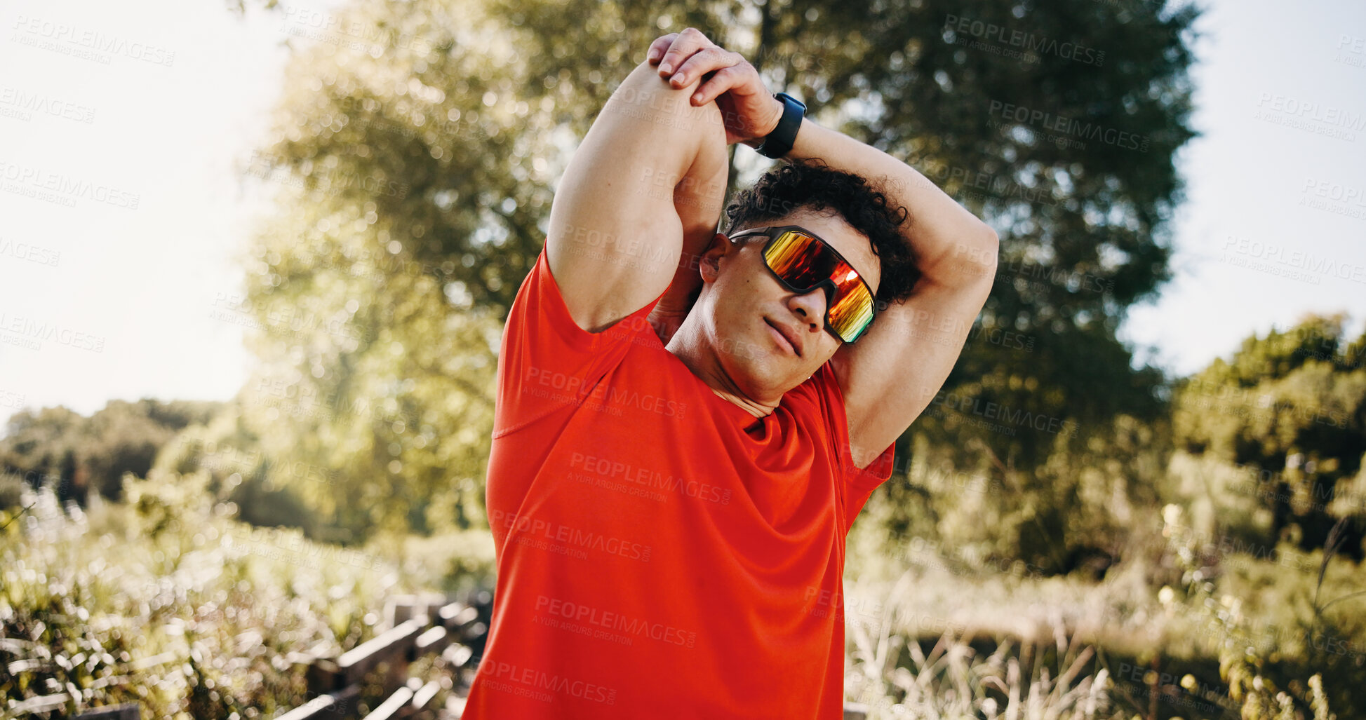 Buy stock photo Stretching, arms and man in nature with sunglasses for exercise, workout and training for wellness. Athlete, runner and person with warm up for health, cardio and fitness with polarized lens outdoor