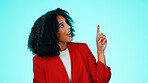 Happy, business and woman in studio, pointing up and opportunity on blue background. Smile, person and employee with hand gesture, advertising choice and information for about us and presentation