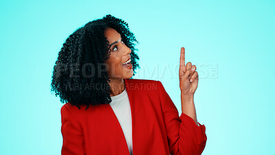 Buy stock photo Happy, business and woman in studio, pointing up and opportunity on blue background. Smile, person and employee with hand gesture, advertising choice and information for about us and presentation