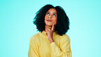 Thinking, wonder and woman in studio, decision and contemplation on blue background. Reflection, unsure and person with choice, thoughtful and looking up for doubt, confused and ponder with questions