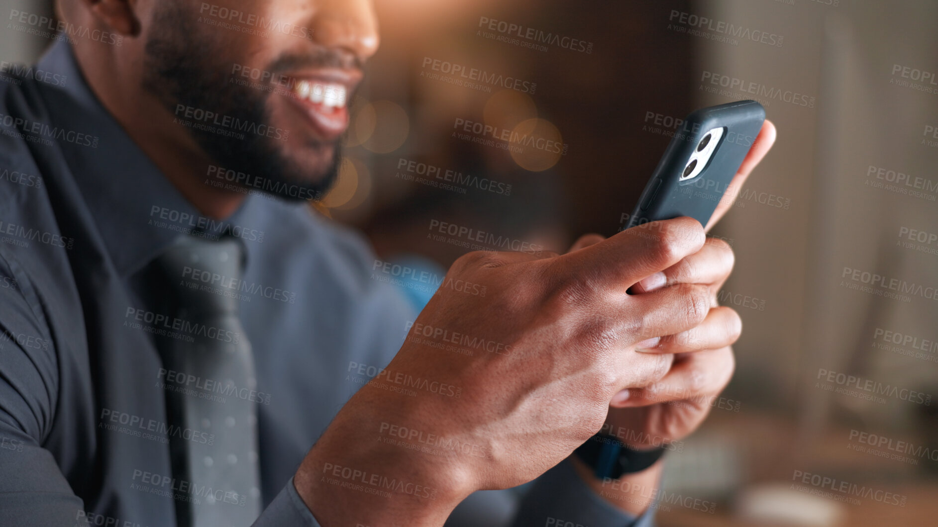 Buy stock photo Hands, phone and texting at night in office with smile, contact and notification at legal agency. Happy man, lawyer and typing with mobile app, feedback and overtime with chat at corporate law firm