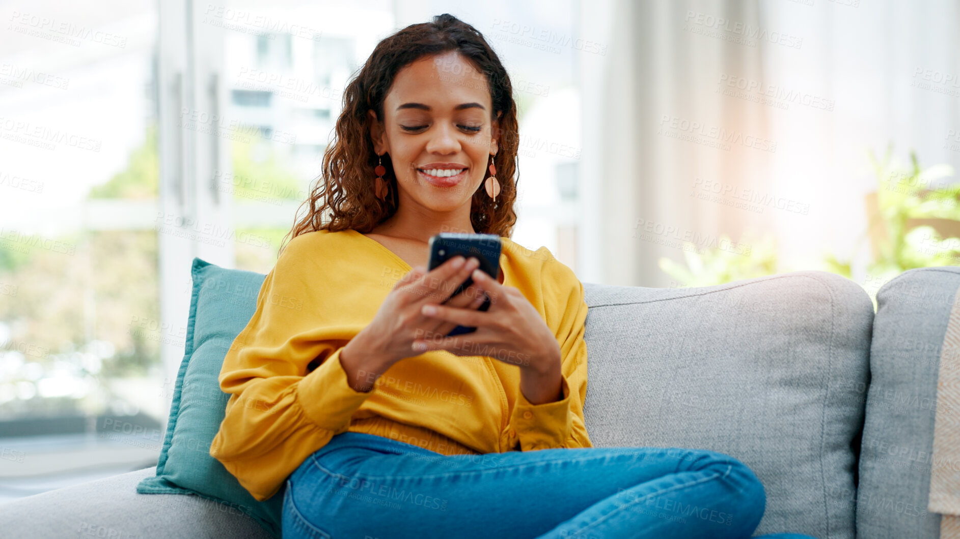 Buy stock photo Smile, mobile and woman in home for relax, social media or download dating app in living room. Phone, sofa and person with matchmaking website for connection search, communication and text message