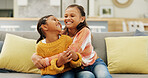 Happy, laugh and sisters hug on sofa for bonding, playful relationship and affection in home. Family, siblings and girls with humor, silly and embrace for love, support and together in living room